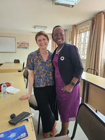 Dr. Katrin Sowa posing with Prof. Sarah Ssali